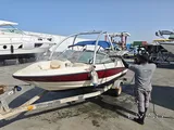 Bayliner 5.3 m boat with trailer, paid parking, and major recent service